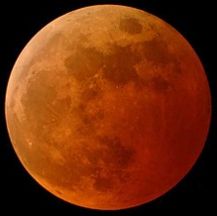 a total eclipse of the moon makes it look orange, not black